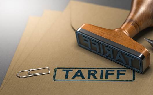 3D illustration of a rubber stamp with the word tariff stamped on paper background. Concept of taxes or duties on imported goods.